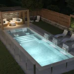 Piscine creusée en fibre de verre Mova, modèle 12x34 - Avec terrasse, finition Diamant couleur Mova, ambiance soirée éclairée