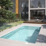 Piscine creusée en fibre de verre Mova, modèle 12x24 - Pente, finition Diamant couleur Mova, ambiance jour
