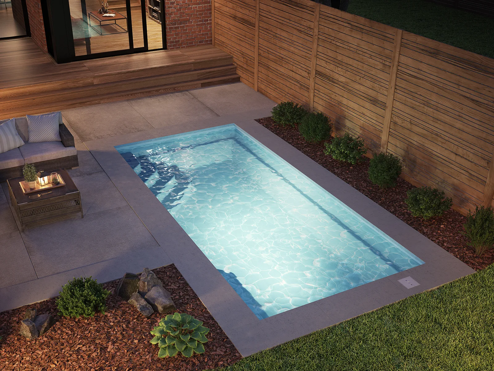 Piscine creusée en fibre de verre Mova, modèle 10x20, finition Diamant couleur Mova, ambiance soirée éclairée